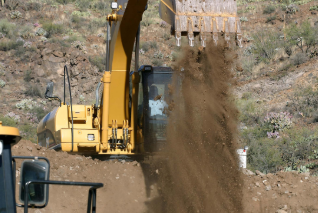 Photo of excavator dumping dirt
